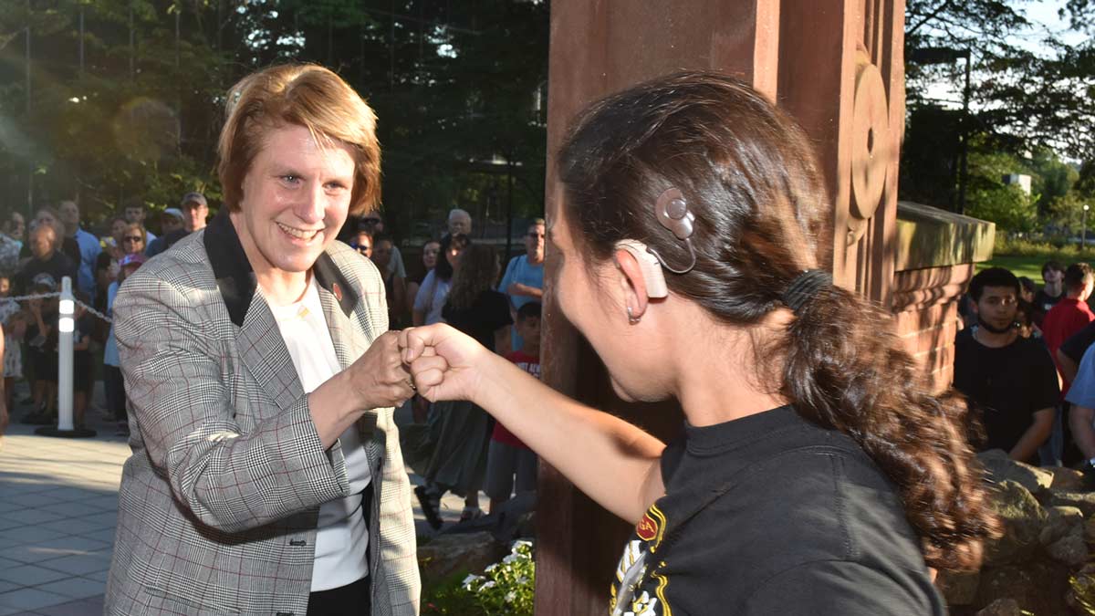 President Jebb fist bumping a student during 69ɫƵ's welcome Arching ceremony